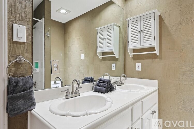 A bathroom with a white sink and a mirror.