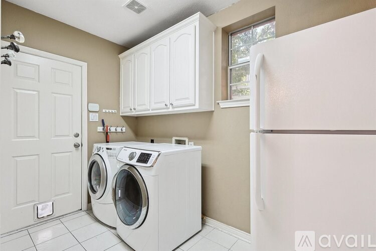 A white washer and dryer in a laundry room.