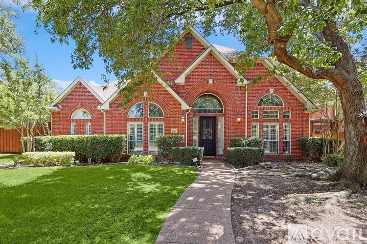 A red brick house with a black door and windows.