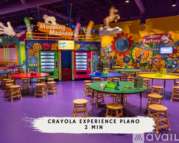 A colorful indoor play area with tables and chairs.