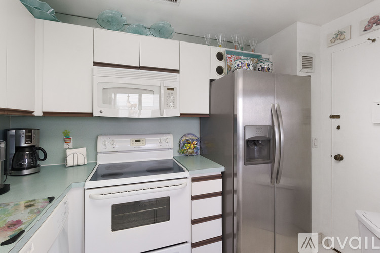A kitchen with a white oven and a stainless steel refrigerator.