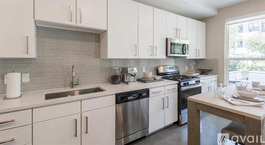 A kitchen with white cabinets and stainless steel appliances.