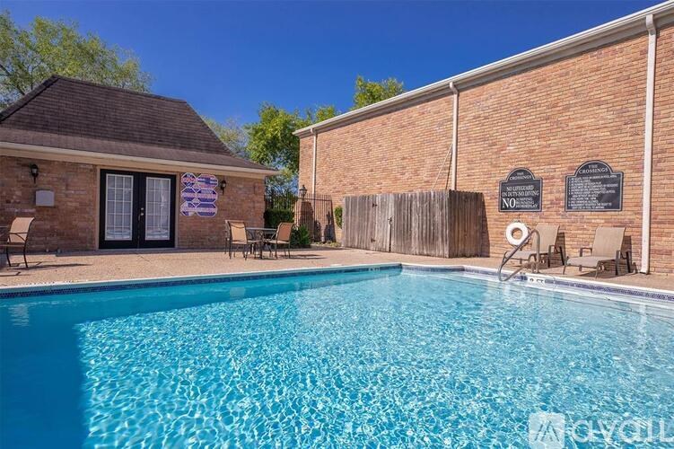 A pool in front of a brick building with a sign that says "NO".