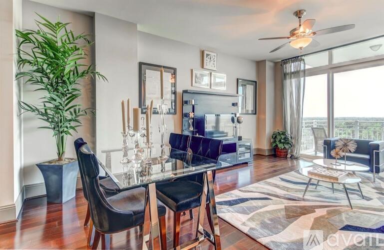 A living room with a glass table and chairs.