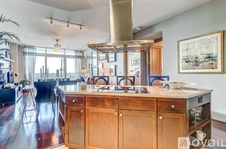 A modern kitchen with a wooden island and a large window.