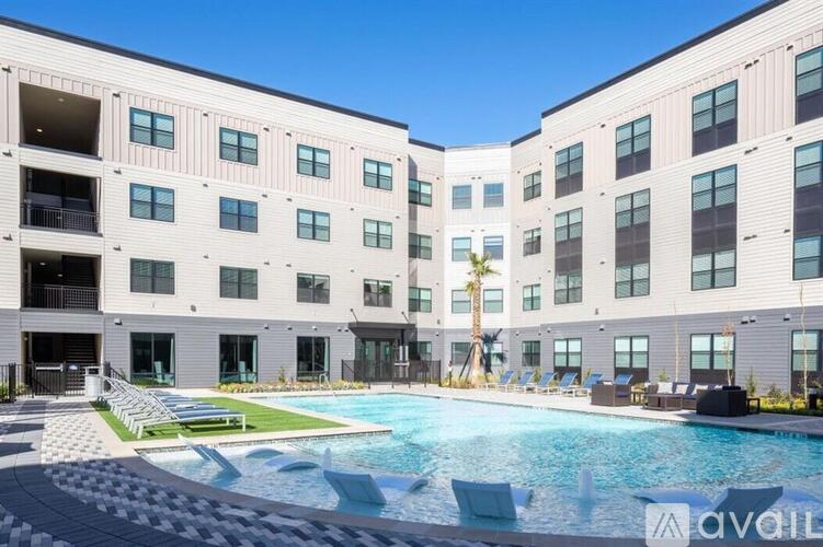 A large pool in front of a building with a sign that says "available".