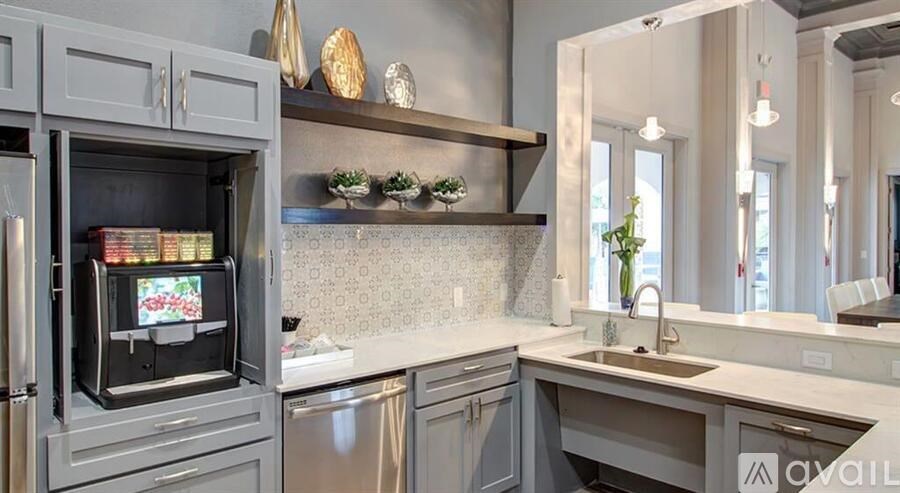 A kitchen with a refrigerator, sink, and shelves.