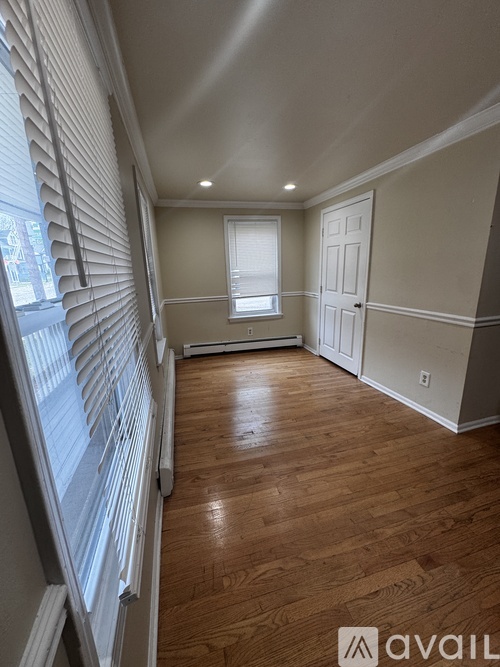 A room with wooden floors and white walls.