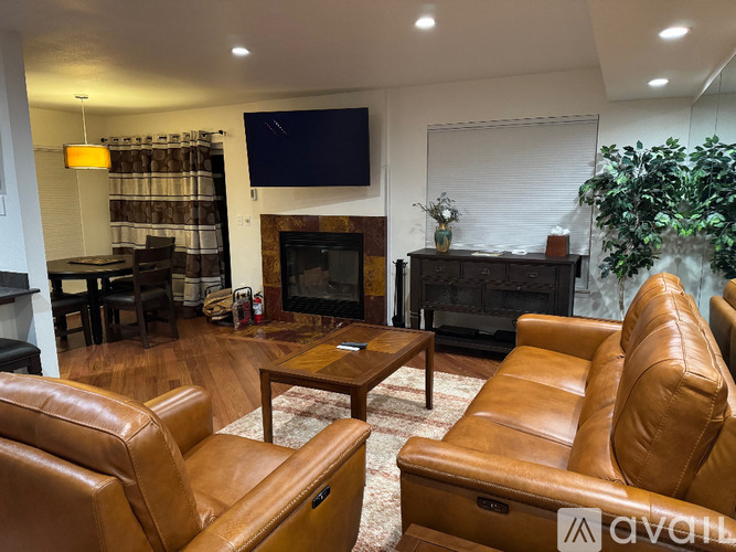 A spacious room with a carpeted floor and white walls.