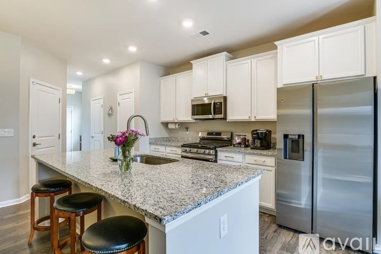 A kitchen with granite countertops and stainless steel appliances.