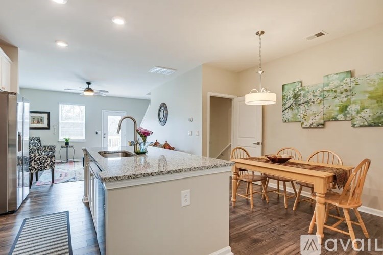 A kitchen with a dining table and chairs.