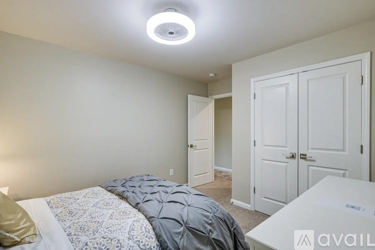 A bedroom with a bed, a dresser, and a nightstand.