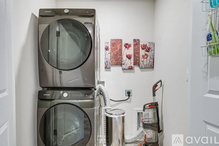 A stack of washing machines with a hose attached to the top one.