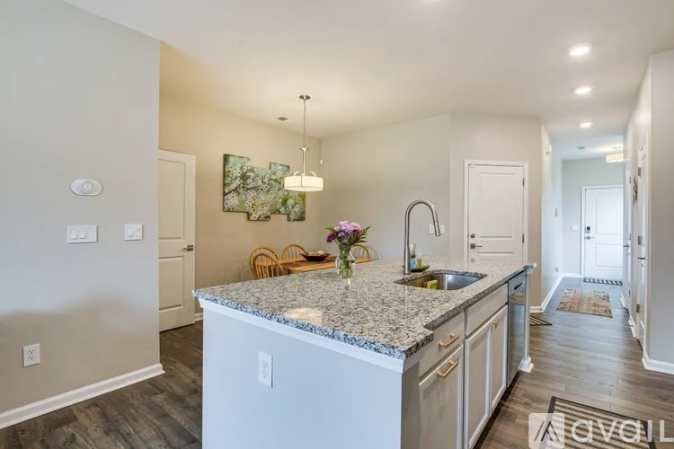A kitchen with granite countertops and a white dishwasher.