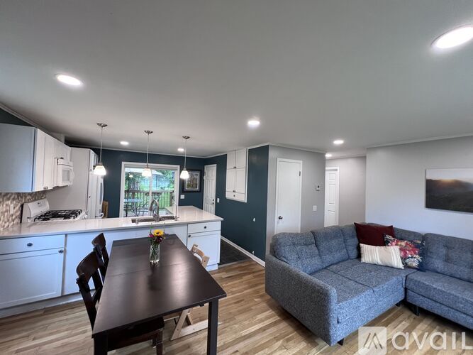 A kitchen with a table and a couch.