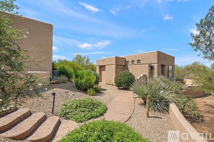A house with a garden in front of it is for sale.