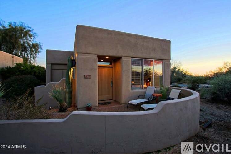 A modern house with a patio and a flag on the door.