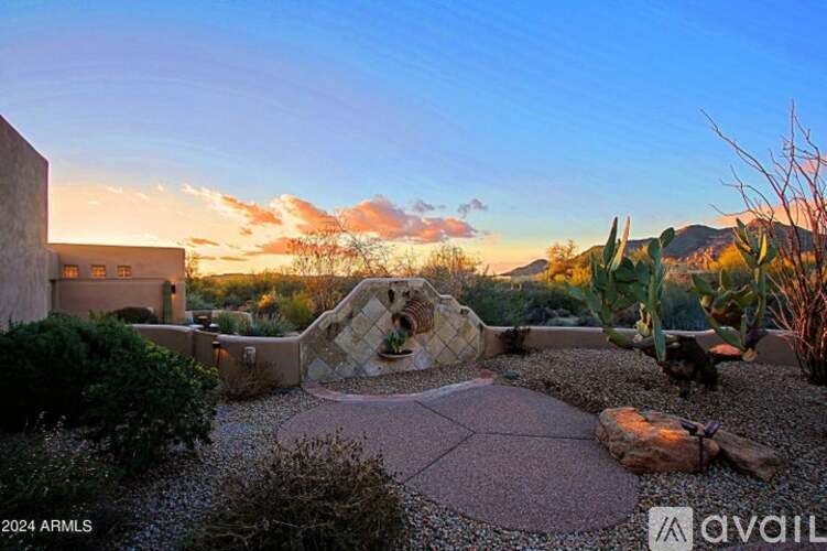 A backyard with a patio and a fire pit.