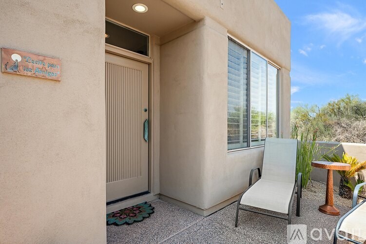 A patio with a chair and a table is shown.