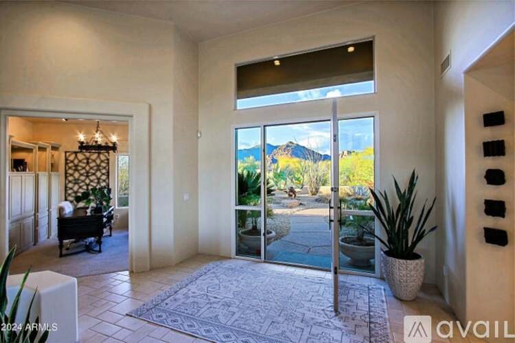 A modern house interior with a view of the mountains.