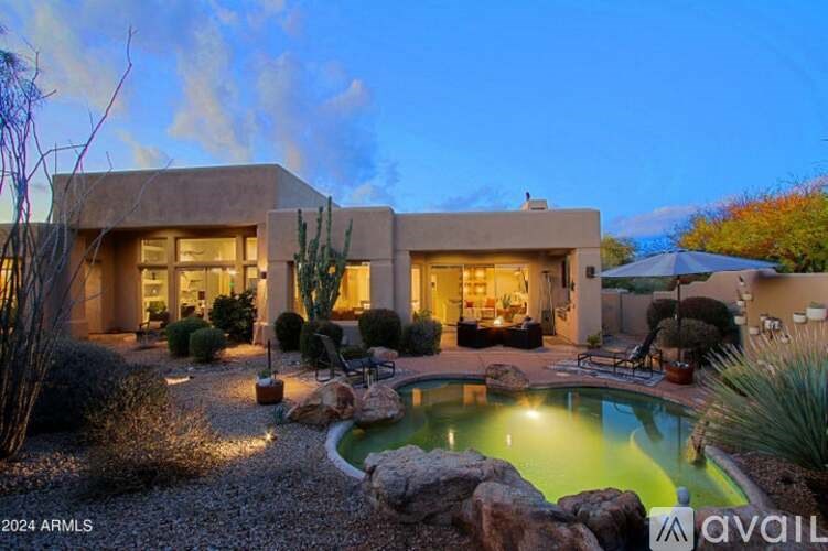 A modern house with a pool in the backyard.