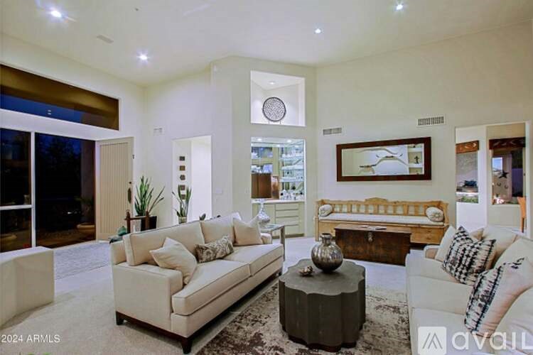 A living room with a white couch and a coffee table.