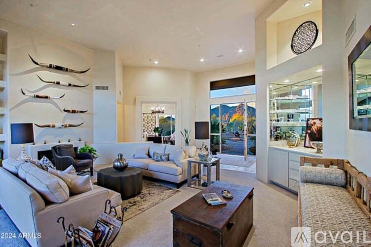 A living room with a white couch and a coffee table.