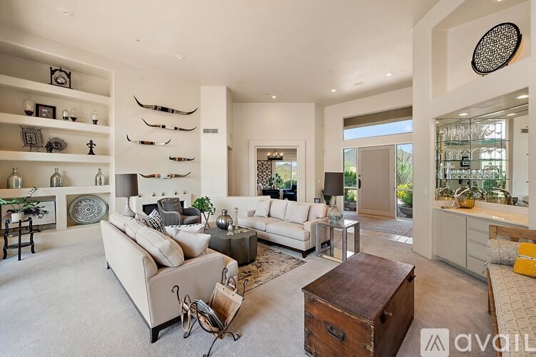 A living room with a white couch and a wooden coffee table.