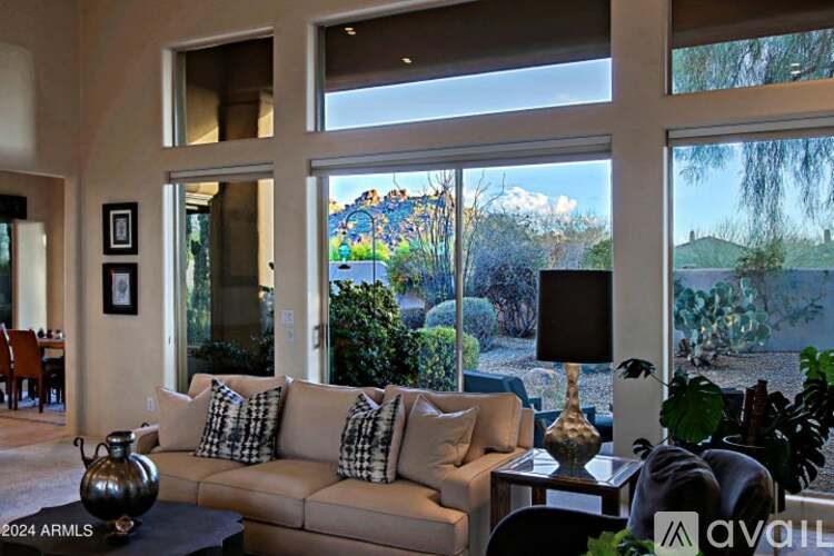 A living room with a couch, a table, and a vase.