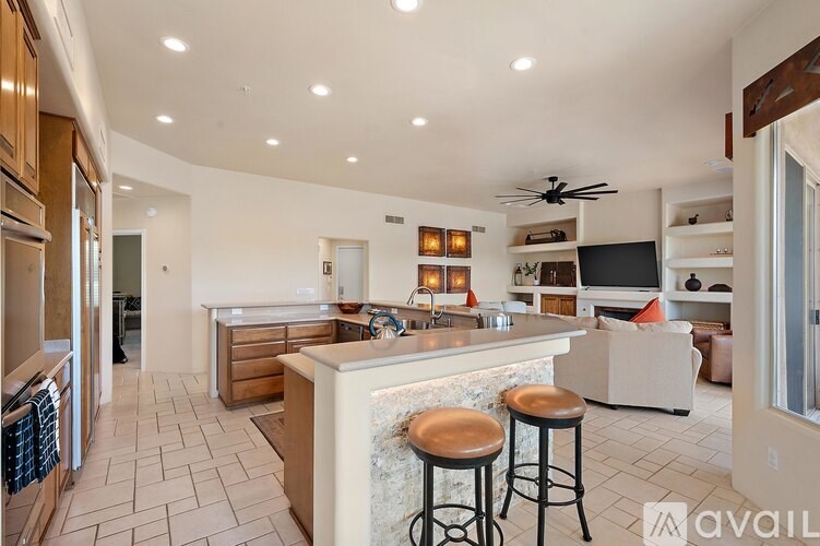 A kitchen with a bar area and a refrigerator.