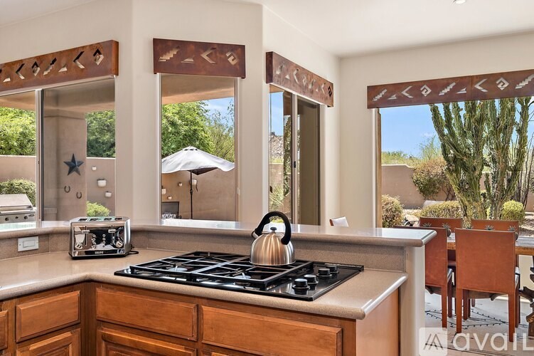 A kitchen with a stove top oven and a toaster on the counter.