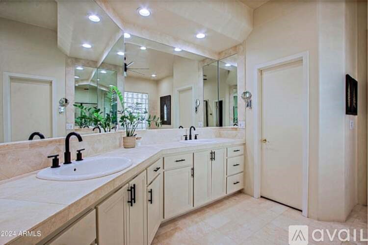 A bathroom with two sinks and a large mirror.