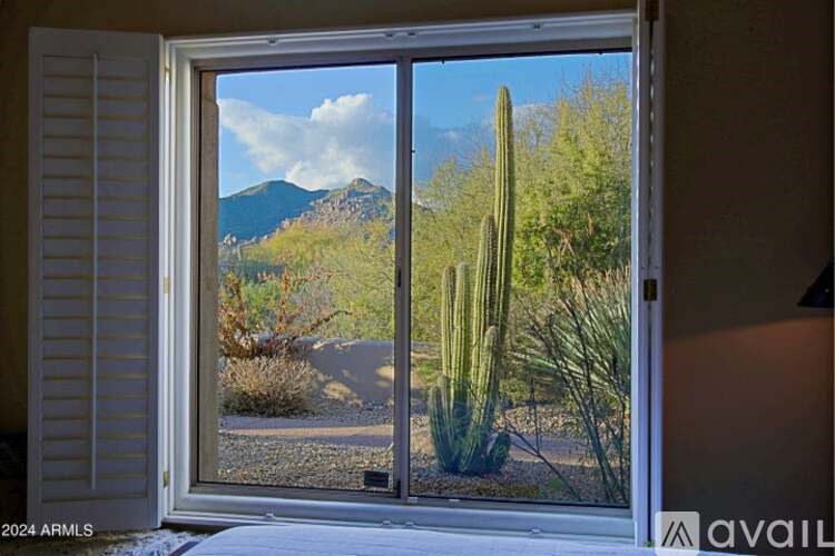 A view of a desert landscape through a window.
