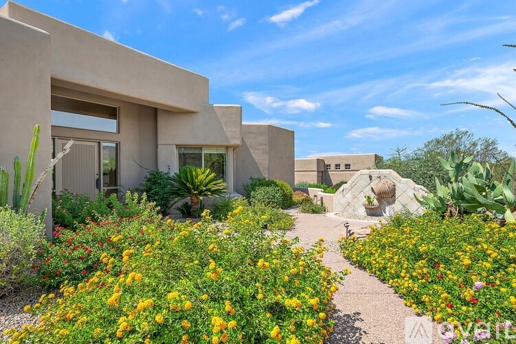 A modern house with a garden in front.