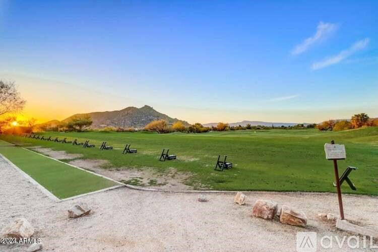 A beautiful landscape with a mountain in the background and a sign in the foreground.