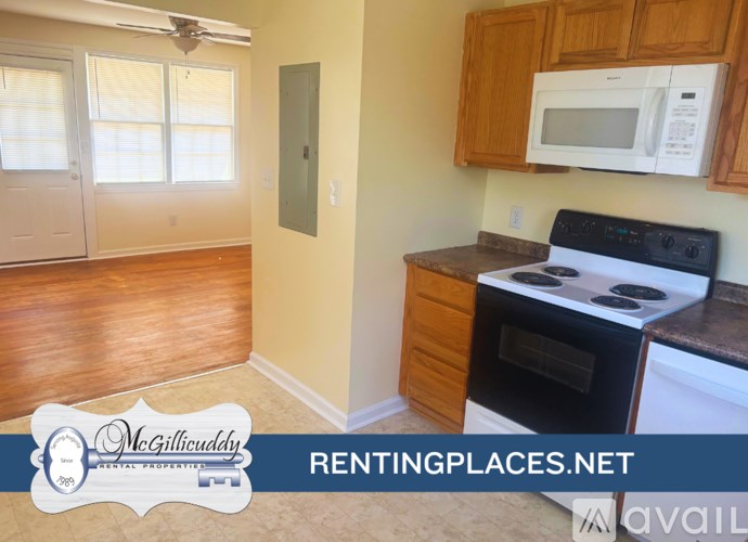 A kitchen with a stove, microwave, and oven.