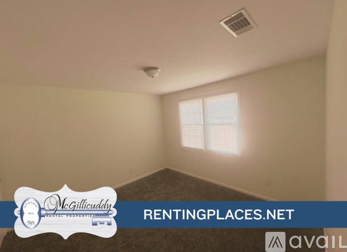 A room with a window and a sign that says McGillicuddy on it.