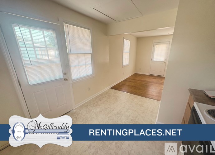 A room with a window and a door is on the market for rent.