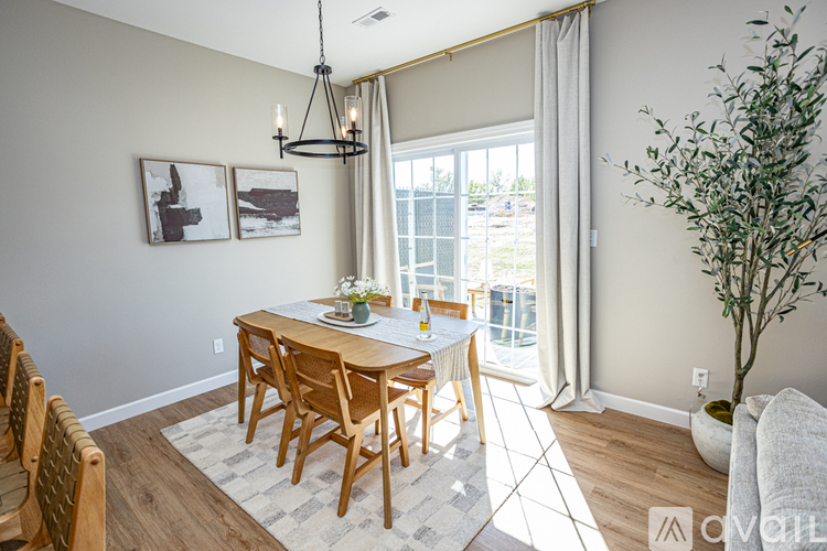 A dining room with a wooden table and chairs.