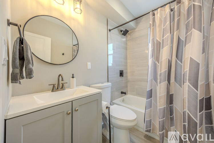A bathroom with a white sink and a white toilet.