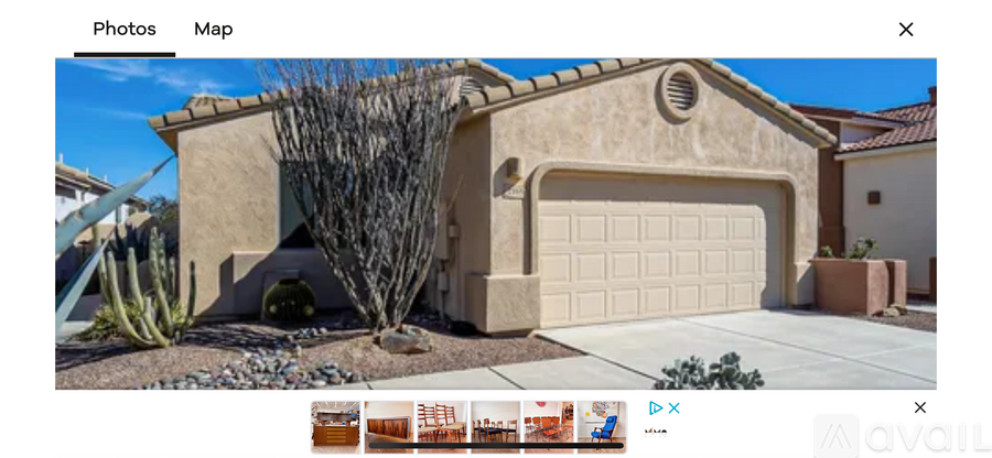 A house with a beige garage door and a small window above it.