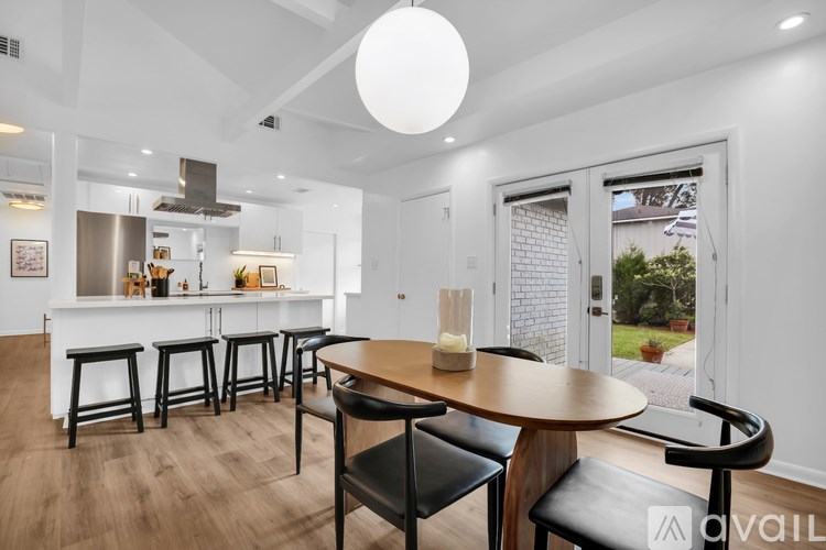 A modern kitchen with a dining table and chairs.