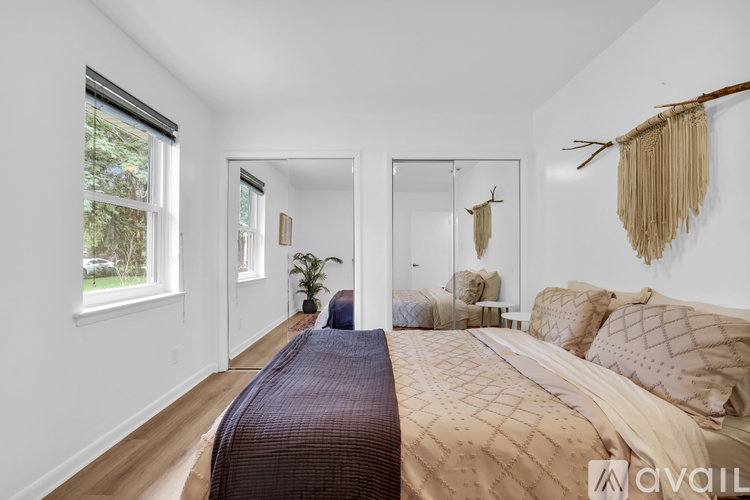 A bedroom with a large bed and a mirror on the wall.