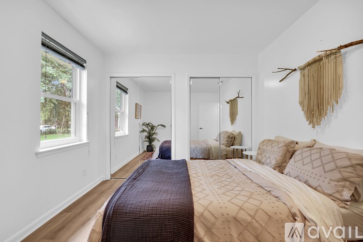 A bedroom with a large bed and a mirror on the wall.