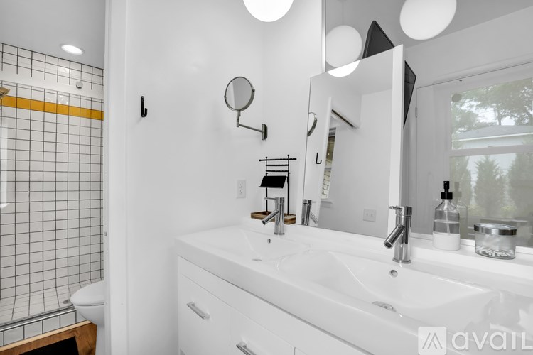 A bathroom with a white sink and a mirror above it.