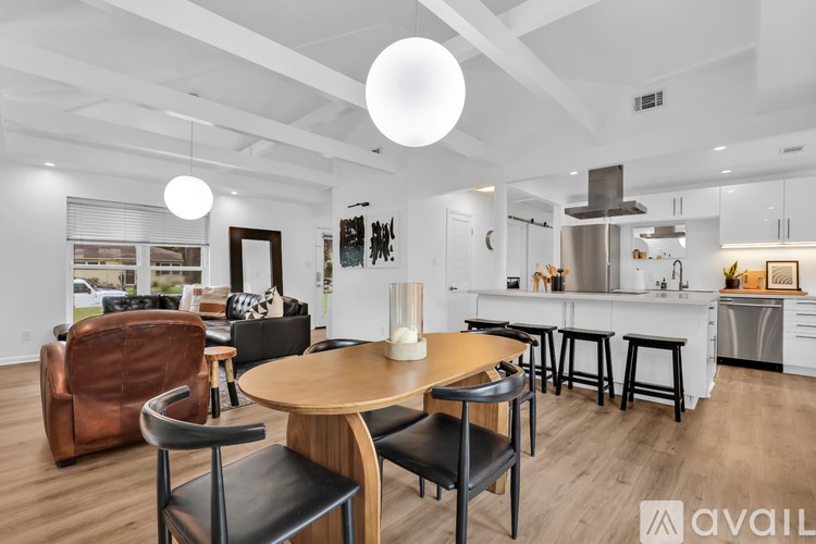 A modern kitchen with a dining table and chairs.
