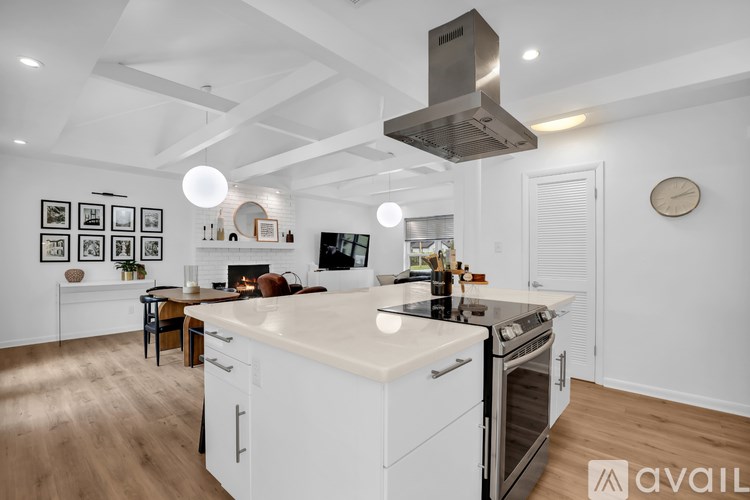 A modern kitchen with white cabinets and a large island.