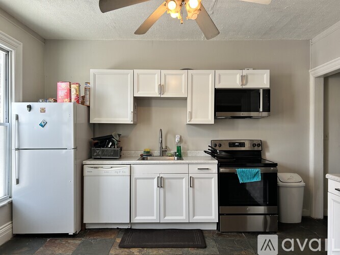 A kitchen with a fan and a window.