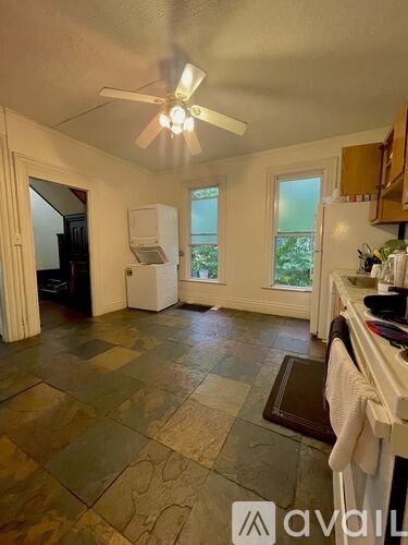 A kitchen with a fan and a window.