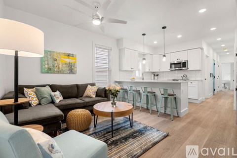A modern living room with a grey sofa and a wooden coffee table.